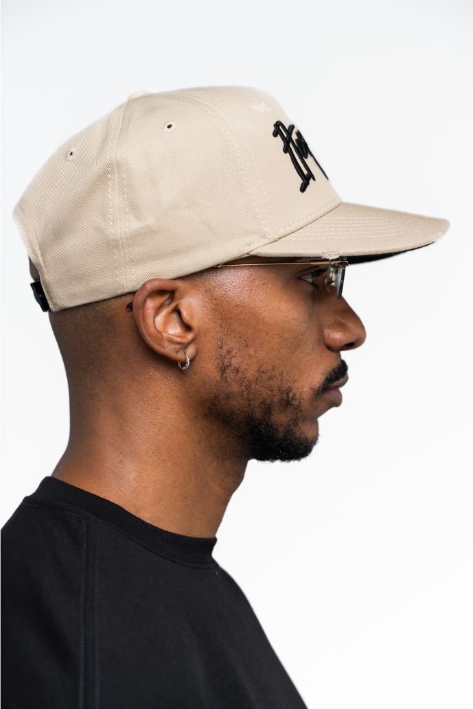 Detalle del material y costuras de la gorra beige de Iterniti, con acabado premium